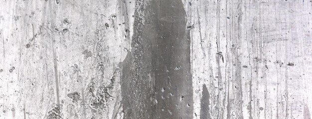 Stary brudny betonowy mur jako tło Szary tynk cementowy Tekstura ściany na tle Zadrapania pędzlem na ścianie