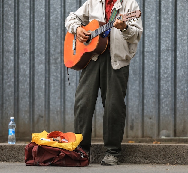 stary muzyk uliczny z gitarą