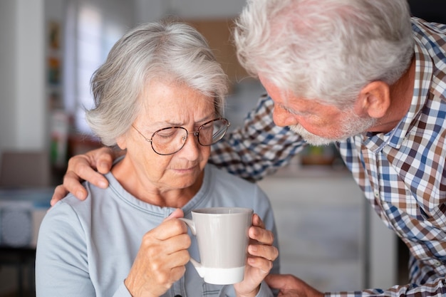 Zdjęcie stary starszy mężczyzna pocieszający swoją żonę z depresją, nieszczęśliwą starszą kobietę w domu, potrzebuje pomocy medycznej ourmindsmatter
