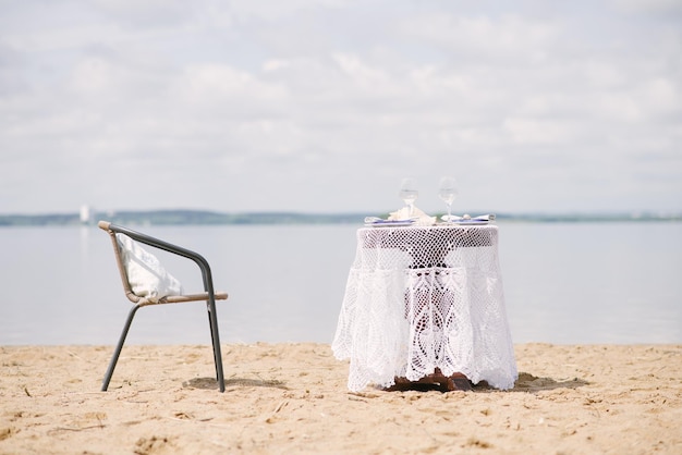 Stół i krzesło na romantyczną kolację nad jeziorem lub oceanem na miesiąc miodowy