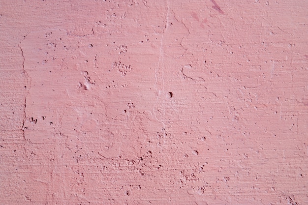 Streszczenie różowym tle. Stare tekstury ścian. Chropowata powierzchnia sztukaterii.