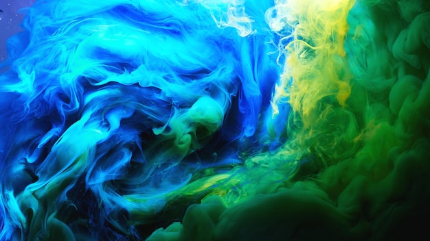 Streszczenie taniec kolorowe tło dymu. Chmury dymu niebieskiego, zielonego i żółtego, wir farb