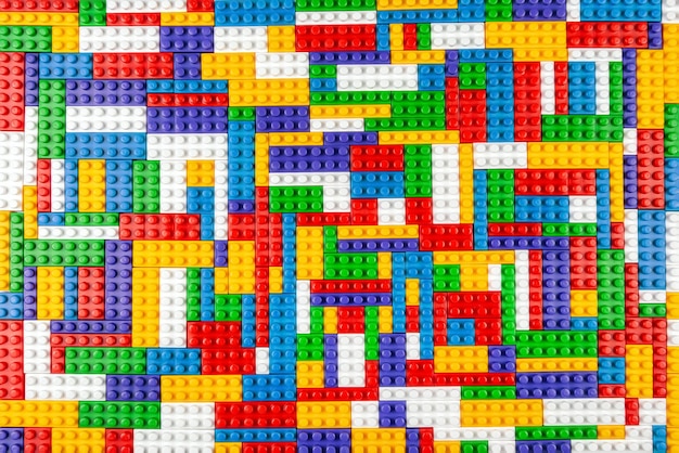 Streszczenie tekstura tła kolorowych bloków konstruktora Tło kolorowe plastikowe części konstruktora Stos kolorowych klocków zabawek