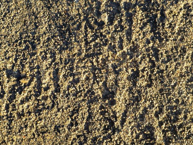 Struktura materiału Nierówna powierzchnia piasku Pod stopami Brązowe tło
