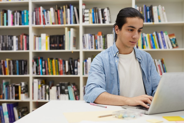 Student Z Ameryki łacińskiej Za Pomocą Laptopa W Bibliotece