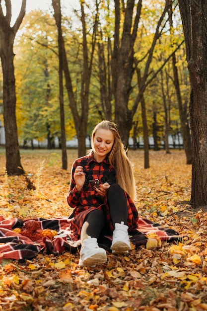 Styl życia portret szczęśliwej kobiety w jesiennym parku piękna dziewczyna na pikniku przyrodniczym na kempingu relaks