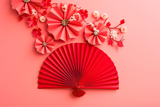 Stylowe kółko wentylatora z czerwonego papieru i czerwony kwiat oraz na różowym tle Dekoracja chińskiego nowego roku Tradycyjny japoński styl Przestrzeń