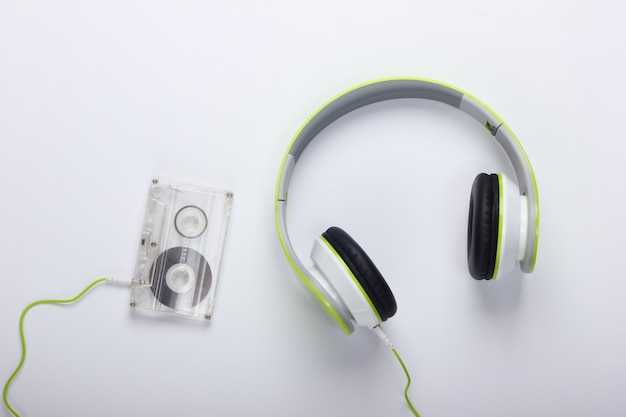 Stylowe przewodowe słuchawki stereo z kasetą audio na białej powierzchni