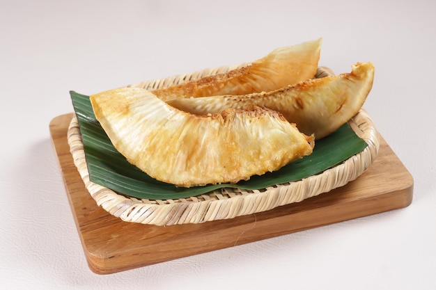 Sukun Goreng lub Smażący Breadfruit na rattanowym talerzu.