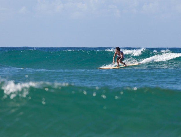 Surfer na longboard jedzie fala w morzu