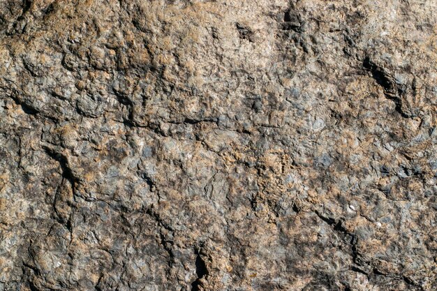 Surowy granitowy kamień tekstura tło Fragment ściany z naturalnego kamienia