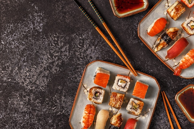 Sushi i sushi rolki na talerzu z pałeczkami