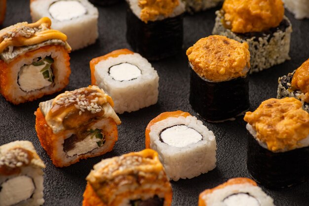 Sushi rolls w rzędach jednolity wzór na czarnym tle makro