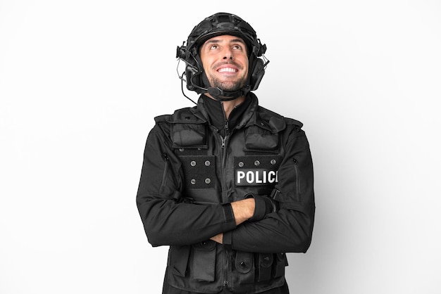 SWAT kaukaski mężczyzna na białym tle patrząc w górę podczas uśmiechu