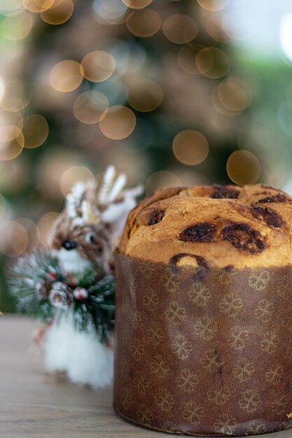 Świąteczny panettone i ozdoba na stole na rozmytym tle