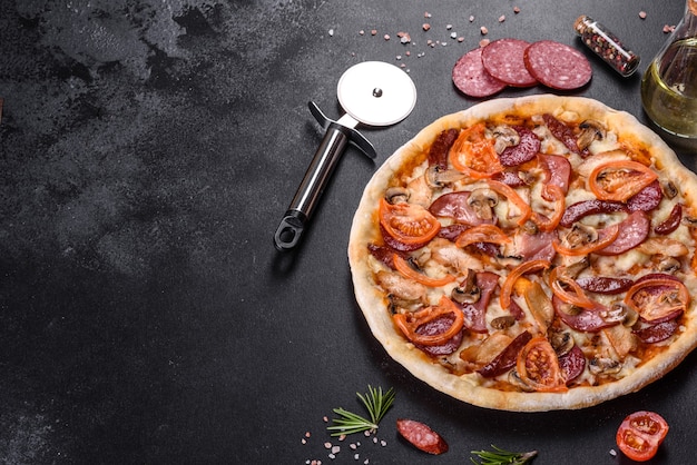 Świeża pyszna pizza pieczona w piecu paleniskowym z kiełbasą, papryką i pomidorami. Kuchnia śródziemnomorska