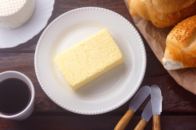 Świeże ekologiczne masło z farmy żółtej wykonane z mleka krowiego na rustykalnym drewnianym stole. domowe jedzenie