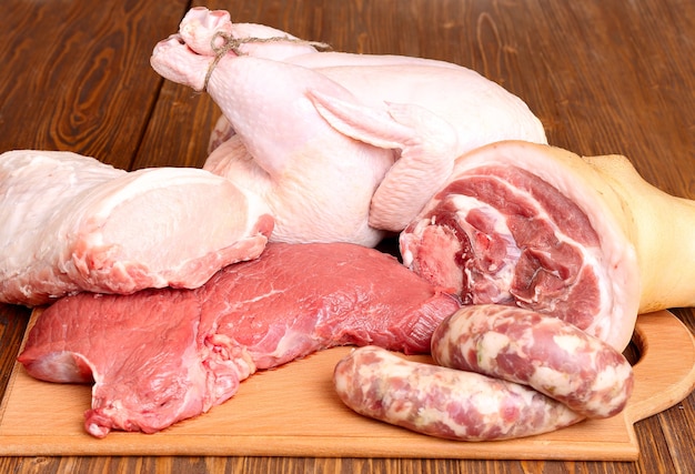 Świeże surowe mięso - wołowina, wieprzowina i kurczak na drewnianym tle