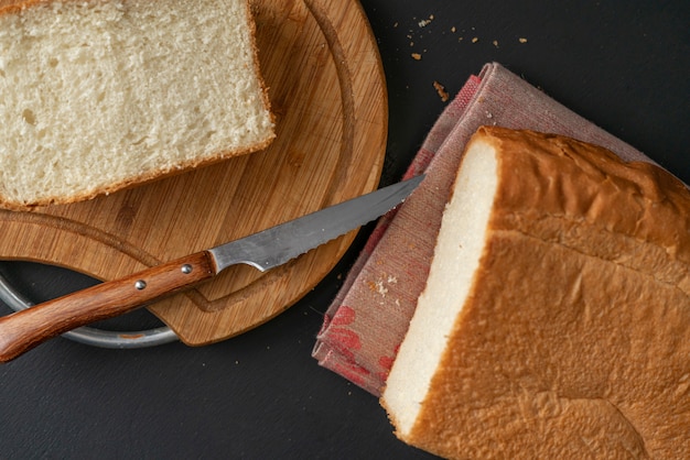 Świeżo upieczony pokrojony biały chleb z metalowym nożem, tosty do gotowania kanapek