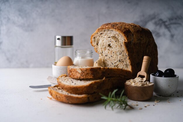 Świeży, pokrojony domowy chleb pełnoziarnisty pszenny na białym tle rustykalnym Artisan Sourdough