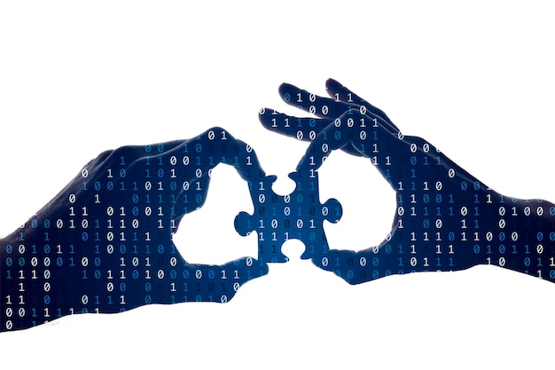 Sylwetka rąk trzymających kawałek układanki z binarnym tłem
