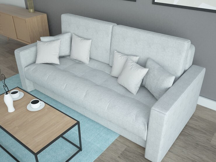 Szara sofa w szarym salonie z wieloma poduszkami