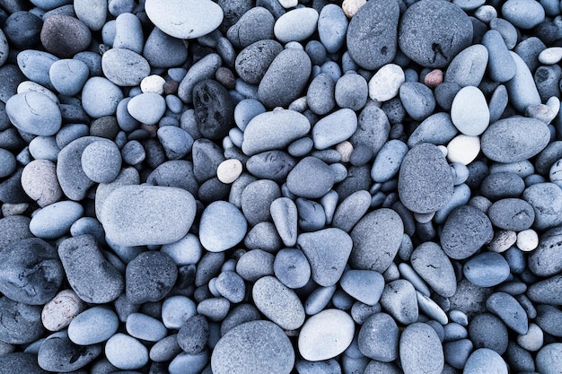 Szare kamyki jako tło Okrągłe kamienie na plaży Fotografia do projektowania Tekstury w przyrodzie