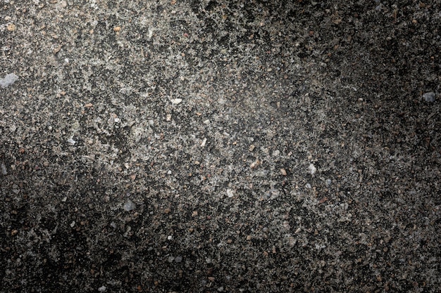 Szare teksturowane tło ściany cementu z drobnymi betonowymi wiórami Tła budowlane