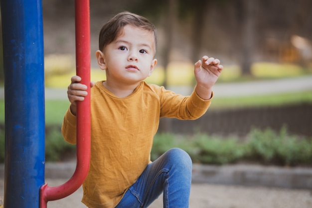 Szczęśliwa młoda chłopiec bawić się outdoors w parku