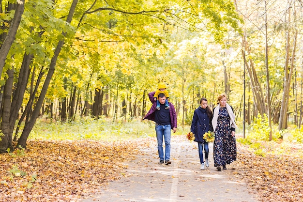 Szczęśliwa młoda rodzina spędzać razem czas na zewnątrz w przyrodzie jesienią