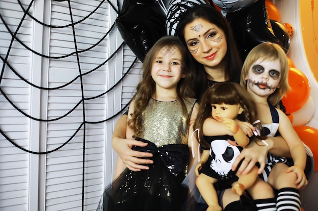 Zdjęcie szczęśliwa rodzina z dziećmi w kostiumach i makijażu na obchody halloween