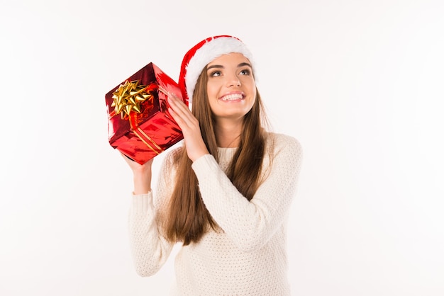 Szczęśliwa zaskoczona dziewczyna w santa hat z prezentami świątecznymi