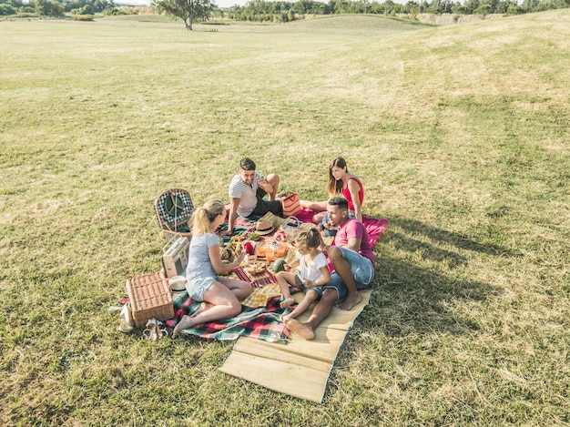 Zdjęcie szczęśliwe rodziny robi pinkinowi w parkowy plenerowym