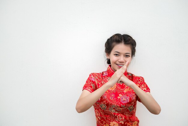 Zdjęcie szczęśliwego nowego chińskiego roku. azjatka z gestem gratulacji ma piękny uśmiech