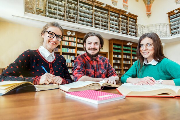 Szczęśliwi studenci piszący w bibliotece