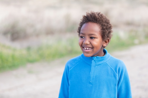 Szczęśliwy afrykański dziecko z błękitnym dżersejem