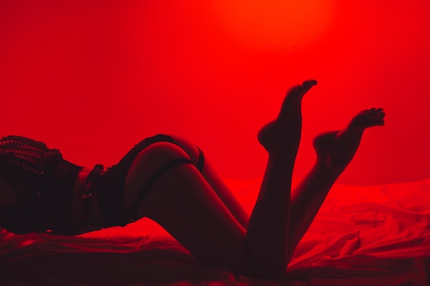 Zdjęcie szczupła kobieta z seksownym ciałem i tyłkiem w pięknej bieliźnie pozuje seksualnie na łóżku