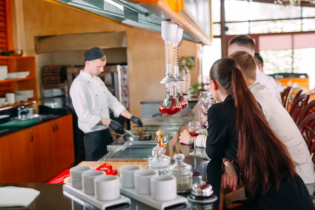 Szef Kuchni Przygotowuje Jedzenie Przed Gośćmi W Restauracji