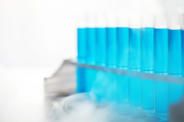 Szklana probówka przelewa się nowym płynnym roztworem błękit potasowy przeprowadza reakcję analizy bierze różne wersje odczynników przy użyciu chemii farmaceutycznej produkcji raka.