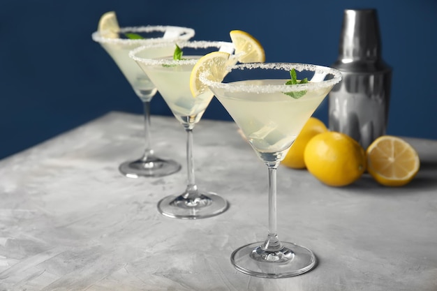 Szklanki ze smacznym cytrynowym koktajlem martini na stole