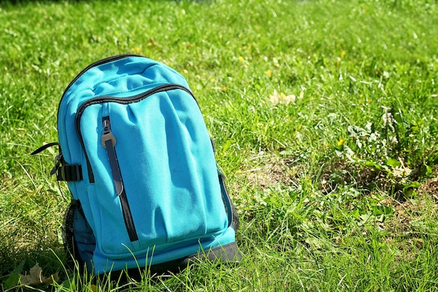 Szkolny plecak na zielonej trawie