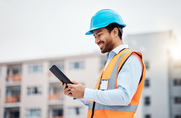 Tablet pracownika budowlanego oraz dane badawcze i cyfrowe do renowacji budynków na zewnątrz Szczęśliwy inżynier i wykonawca z projektem zarządzania i budowniczym z planem technicznym i online