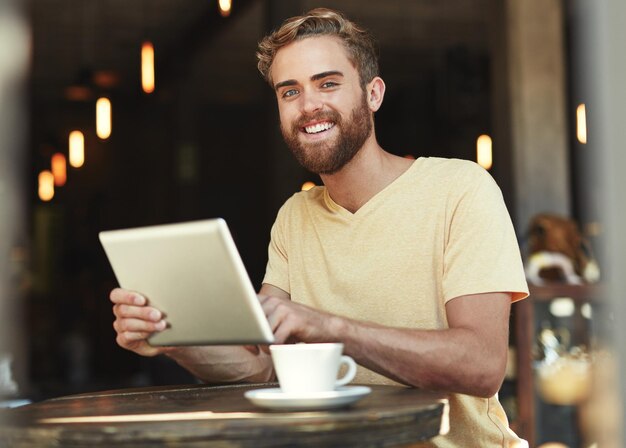 Tablet z portretem w kawiarni i szczęśliwy człowiek pracują nad badaniami projektów online lub recenzują sklep restauracyjny lub usługę kawiarni Uśmiechnij się do szczęścia i osoby pracującej nad danymi lub statystykami dotyczącymi gościnności