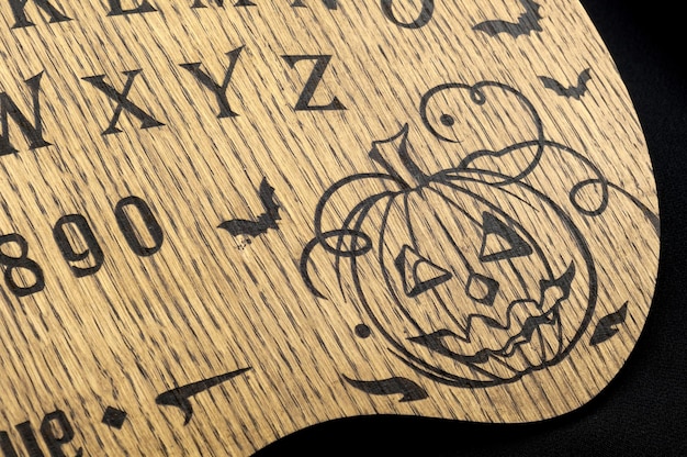 Zdjęcie tablica ouija żółta na czarnym tle