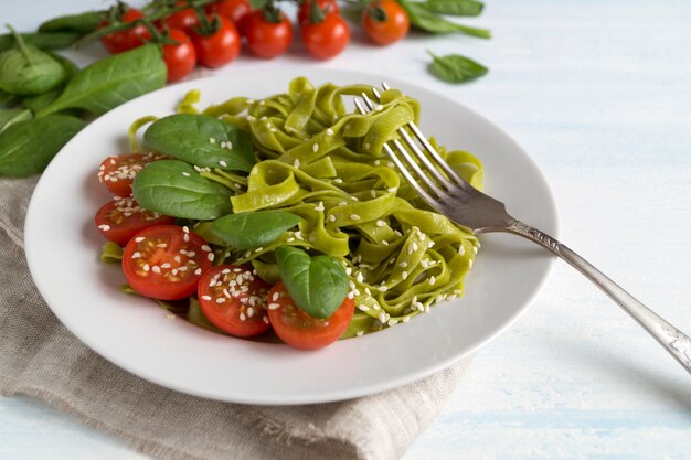 Tagliatelle ze szpinakiem z pomidorkami koktajlowymi. odpowiednia dieta.