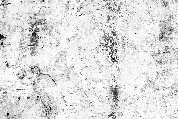 Tekstura betonowej ściany z pęknięciami i rysami, które można wykorzystać jako tło