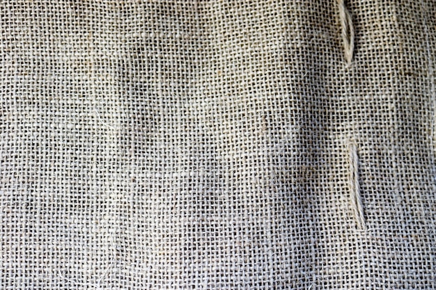 Tekstura brązowego starego płóciennego lnianego naturalnego materiału z grubym prostopadłym przeplotem