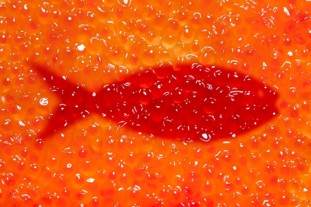 Zdjęcie tekstura czerwonego kawioru ze znakiem ryb