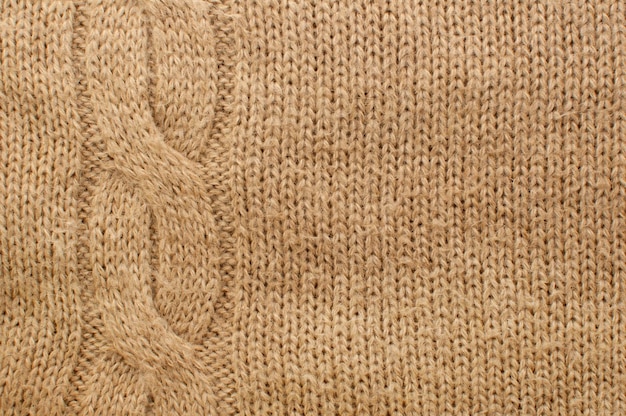 Tekstura dzianinowej wełnianej kraty z jednolitym tłem z wzorem warkoczyka