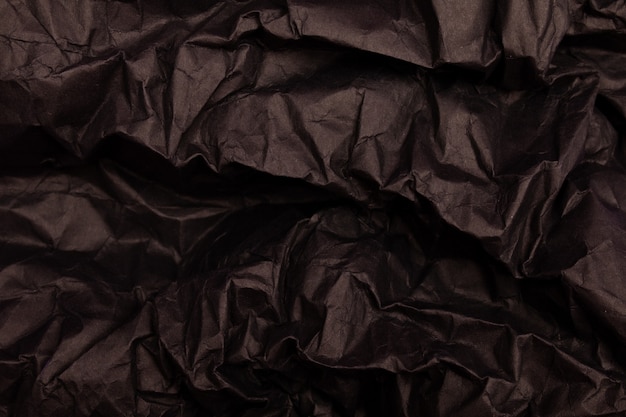 Tekstura lub tło szczegółowego czarnego stonowanego zmiętego papieru